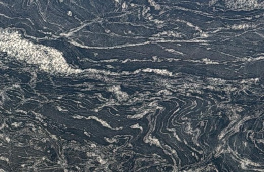Dark tones and contrasting veins in Arabian Nights Granite